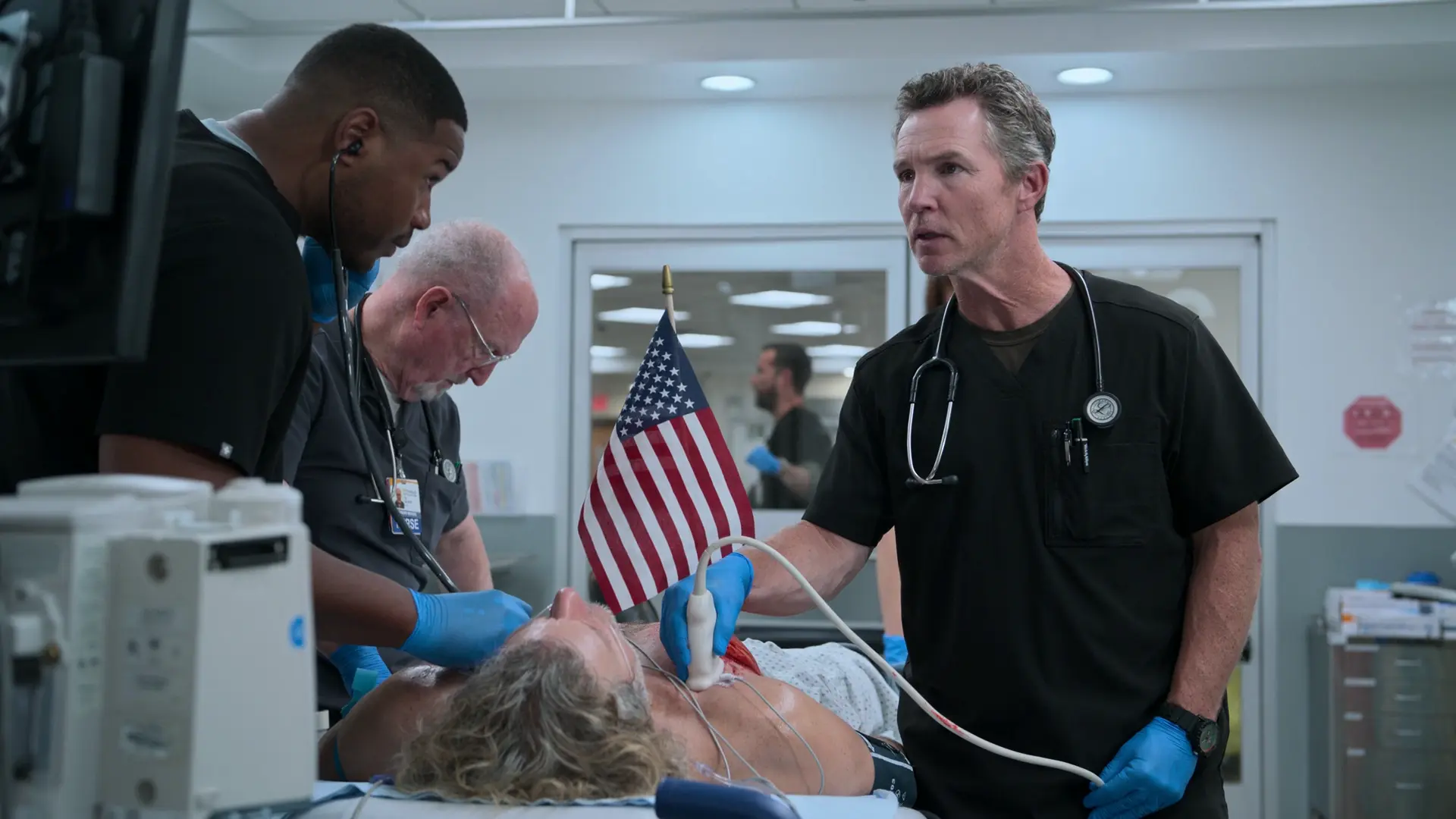 Dr. Abbot performing a Point-of-Care Ultrasound (POCUS) on the patient's anterior chest.