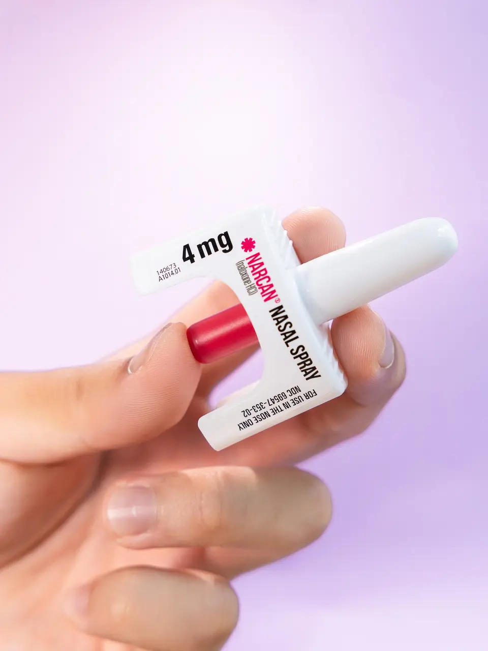 Close-up of a 4mg Narcan (naloxone) intranasal spray device used in rapid opioid overdose reversal.